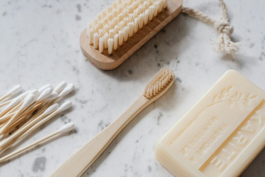 pexels photo 4202483 4202483 From above closeup of wooden cleaning brush and toothbrush and cotton swabs and soap placed on marble surface