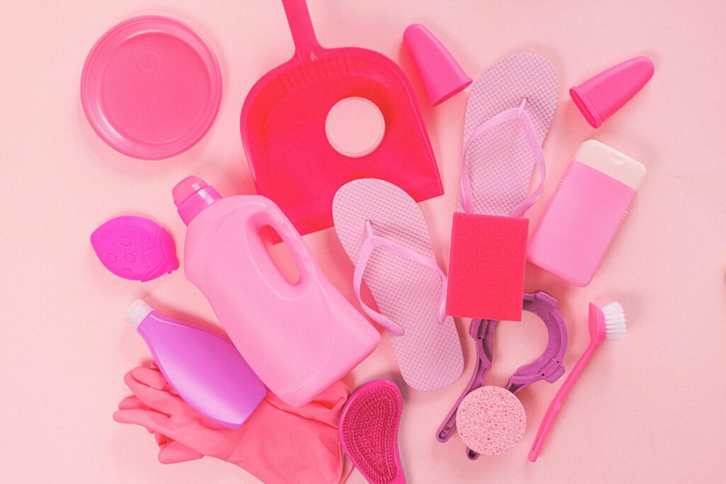 pexels photo 5218022 5218022 Collection of various plastic detergent bottles and cleaning tools placed on pink background near flip flops and rubber gloves
